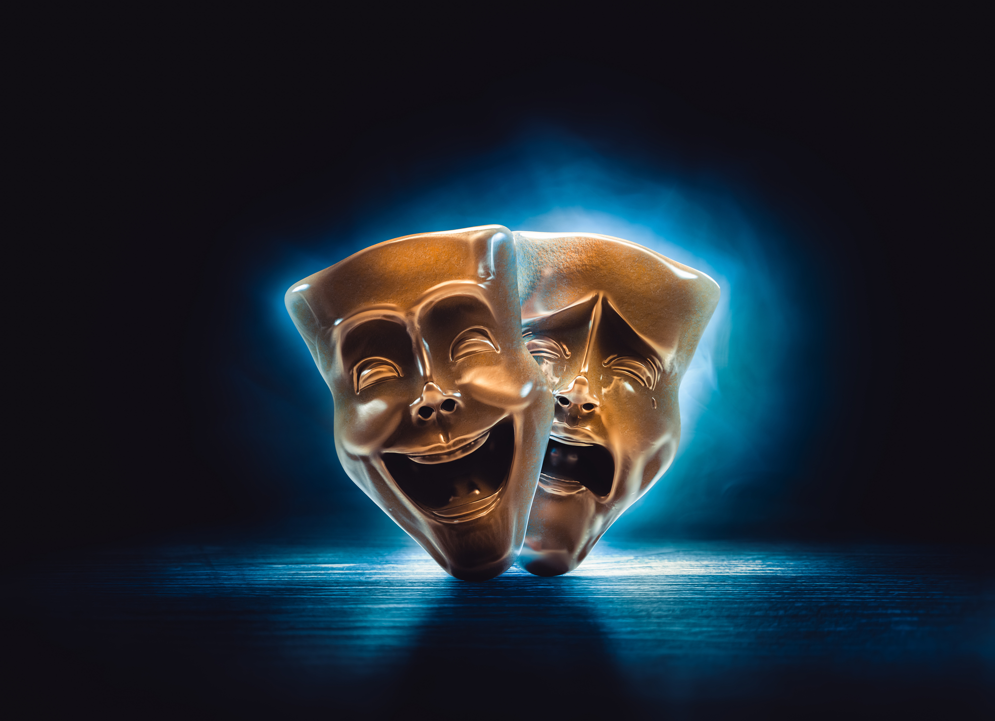 Two theatrical masks, one smiling and one frowning.